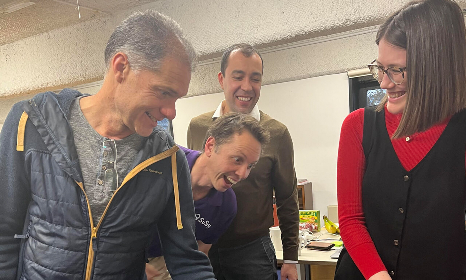 The team a little overexcited for celebratory cake